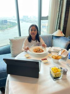 Cara eating room service at Reverie Saigon
